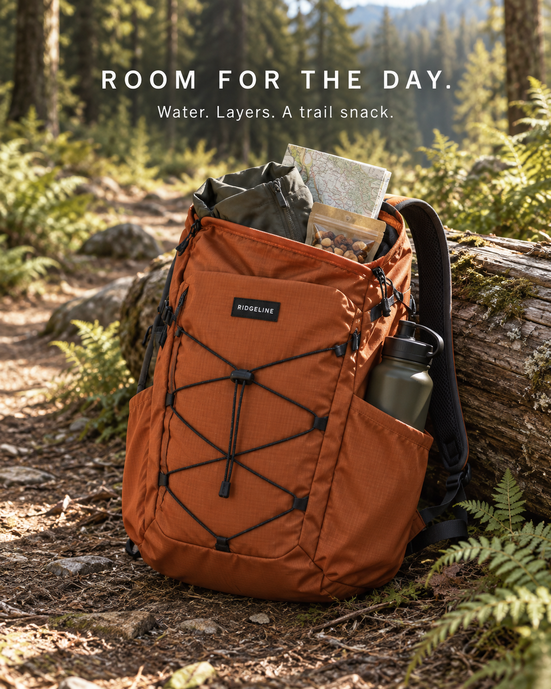 Open backpack with water, layers and a trail snack.